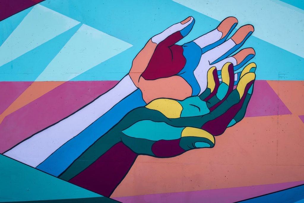 two hands entwined to metaphorically describe equality.